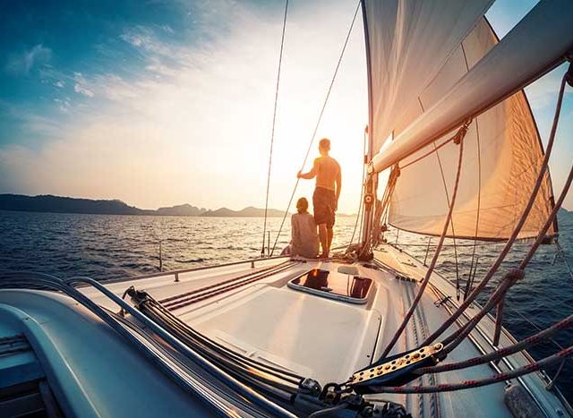 Couple enjoying sunset from the sail boat