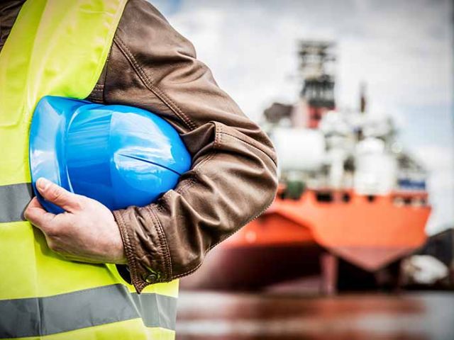 Shipbuilding engineer with safety helmet in shipyard