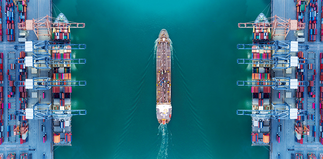 Aerial view panoramic oil tanker moving pass sea port warehouse