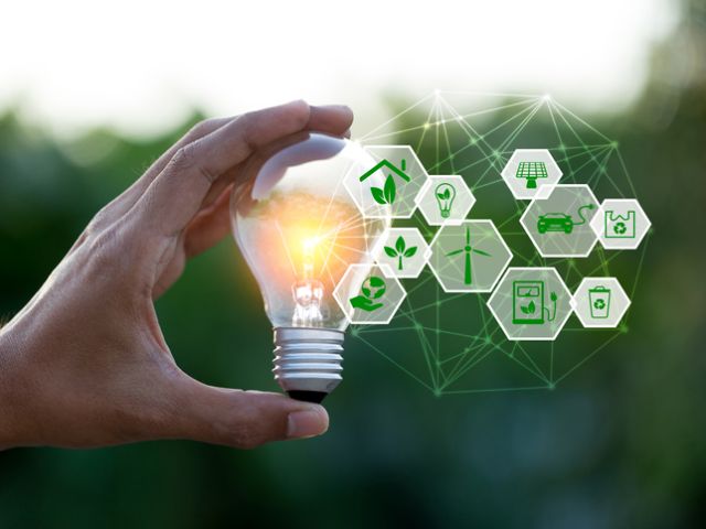 Hand holding light bulb with icons energy sources for renewable,love the world concept.