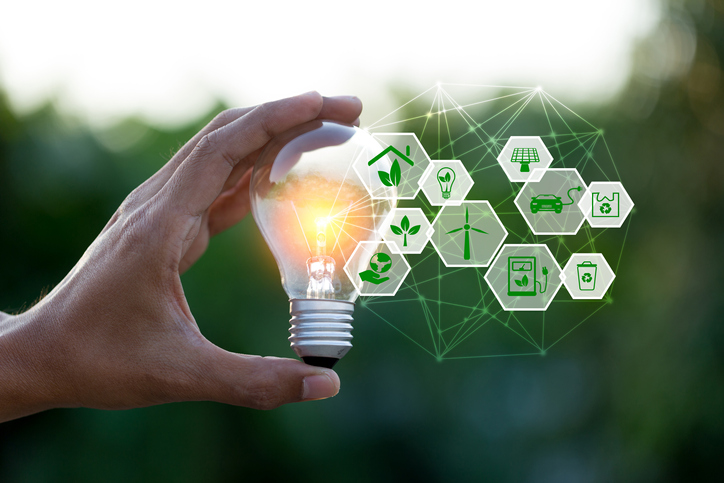 Hand holding light bulb with icons energy sources for renewable,love the world concept.
