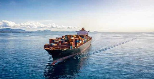 Aerial view of a heavy loaded container cargo vessel