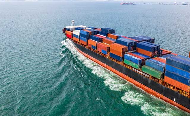 Aerial view cargo container ship sailing, container cargo ship in import export and business logistic and transportation of international by container ship in the open sea.