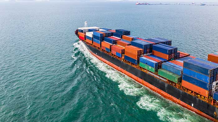 Aerial view cargo container ship sailing, container cargo ship in import export and business logistic and transportation of international by container ship in the open sea.