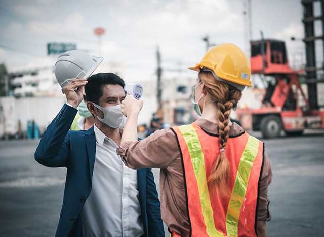 Coronavirus Covid-19 Disease Epidemic Crisis Situation, Construction Worker Having Fever Body Scan by Thermometer Scanning at Construction Site. Corona-Virus Covid19 Prevention of New Normal Concept